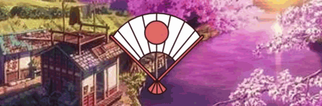 a fan with a red circle in the middle is in front of a house and cherry blossoms