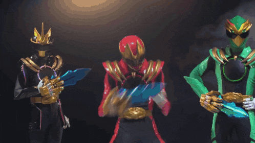 three power rangers are standing next to each other