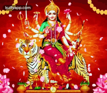 a statue of a woman sitting on top of a tiger surrounded by flowers and petals .