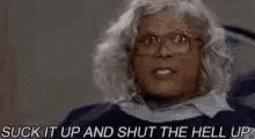 a woman with glasses is screaming and saying `` suck it up and shut the hell up . ''