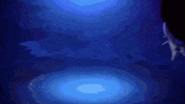 a person is swimming in a dark pool with a blue light behind them