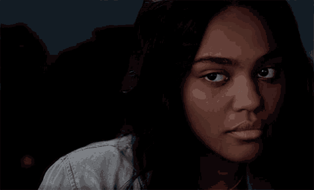 a close up of a woman 's face with dark eyes