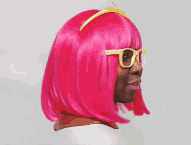 a woman wearing a pink wig and sunglasses is giving a thumbs up