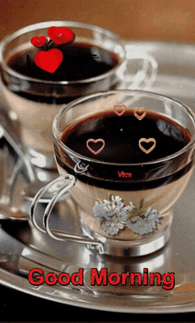 two cups of coffee on a silver tray with the words good morning