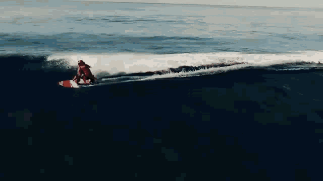 a person is riding a wave on a surfboard