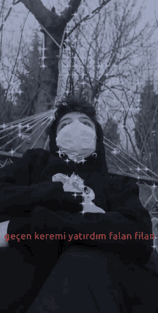 a black and white photo of a man wearing a mask with the words keremi written below him
