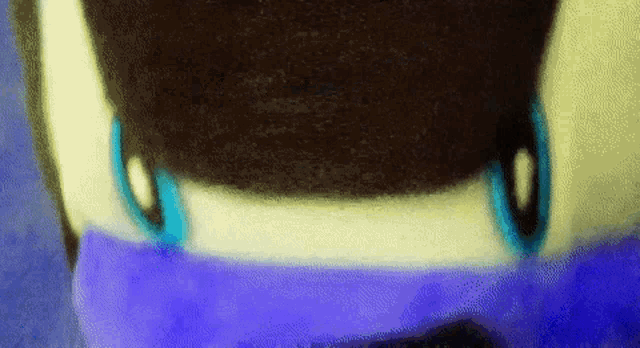 a close up of a blue and white object with a blurred background