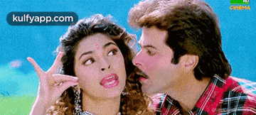 a man is kissing a woman on the cheek in a movie scene