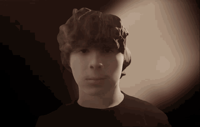 a young man with a very messy hair style
