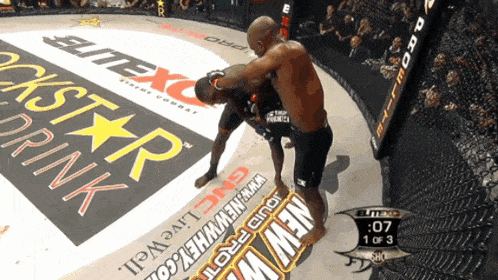 a fighter in a ring with a rockstar energy drink ad