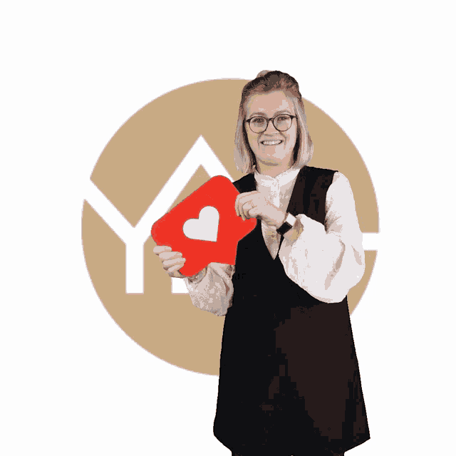 a woman in a black dress is holding a red heart shaped icon