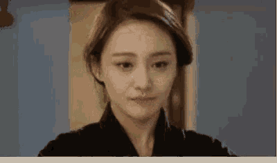 a close up of a woman 's face in a room .