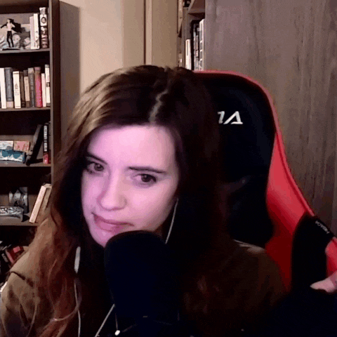 a woman is sitting in a red chair with the letter a on it