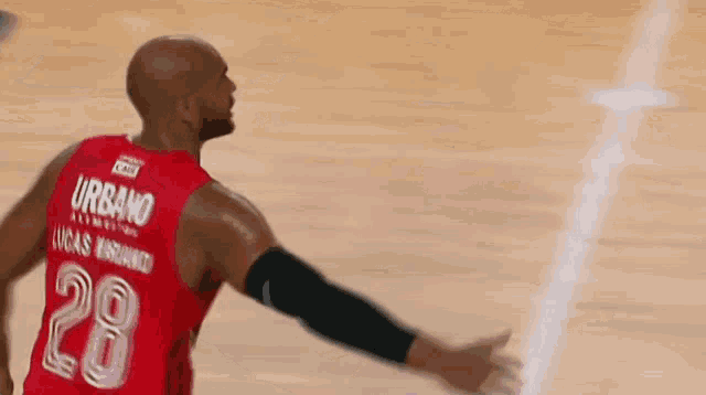 a basketball player wearing a red jersey with the number 61 on it