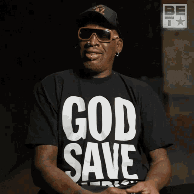 a man wearing a shirt that says god save