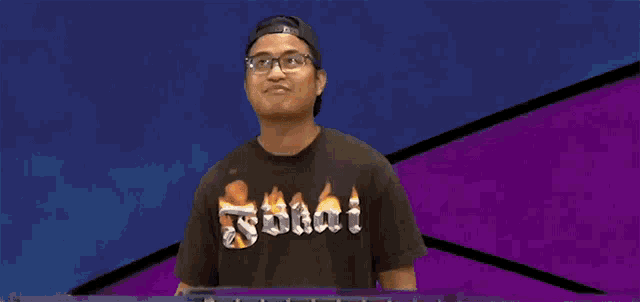 a man wearing a shirt that says ' sdaai ' on the front