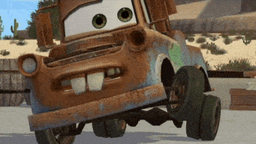a rusty tow truck from the movie cars is sitting on the ground