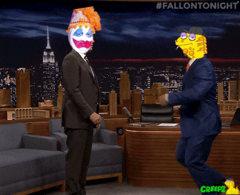 a man in a suit has a yellow face on his head and the words #fallontonight are visible behind him