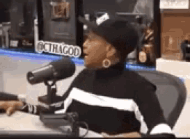 a woman is sitting in front of a microphone .