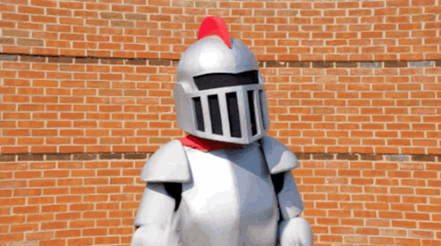 a mascot in a knight costume giving a thumbs up