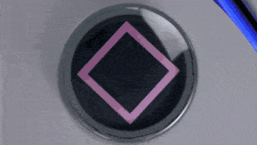 a close up of a playstation controller with a square triangle and arrow buttons