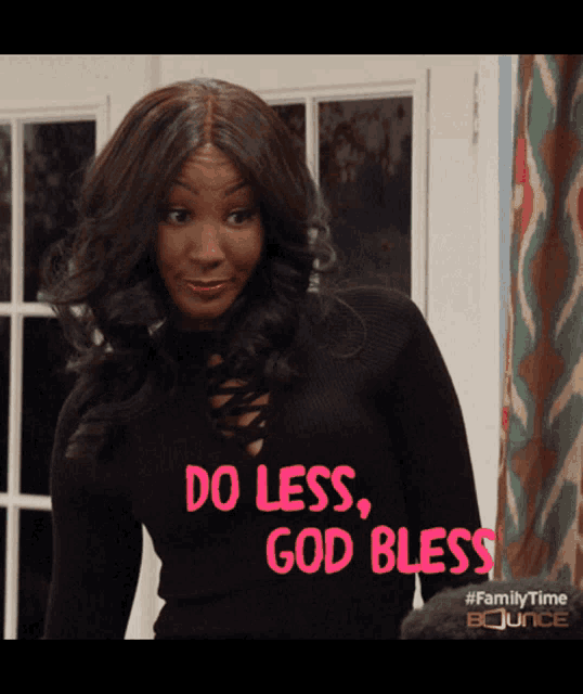 a woman wearing a black sweater with the words do less god bless on it