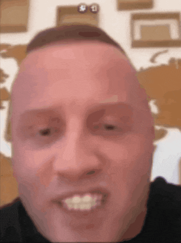 a close up of a man 's face with a smile on it