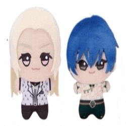 two stuffed dolls with blonde hair and blue hair are standing next to each other .
