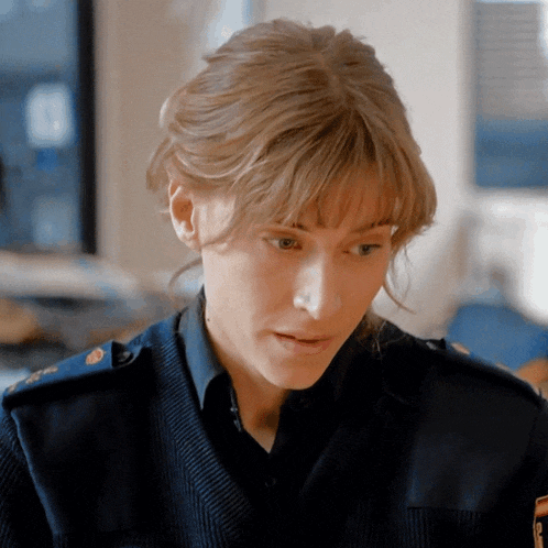 a woman in a military uniform has a patch on her shoulder that says ' polizei '