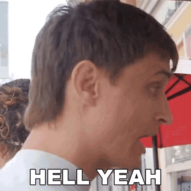 a close up of a man 's face with the words hell yeah on it