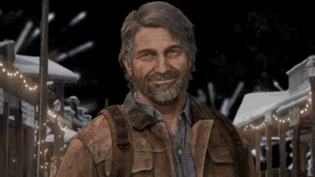 a man with a beard is smiling in front of a snowy town