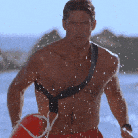 a shirtless man is holding a life preserver in his hand