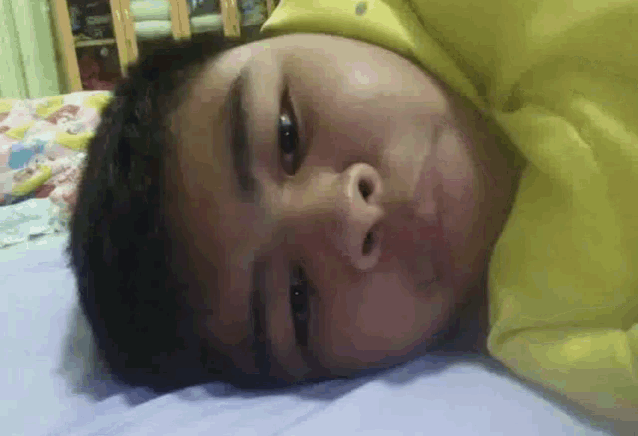 a close up of a person laying on a bed