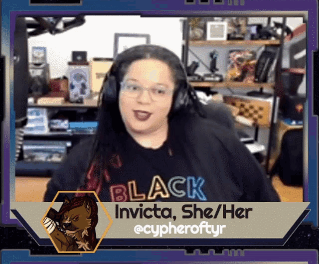 a woman wearing headphones and a black shirt that says invicta