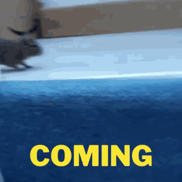 a blue background with yellow text that says coming