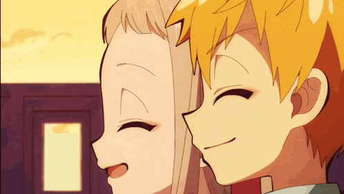 a boy and a girl are standing next to each other smiling .
