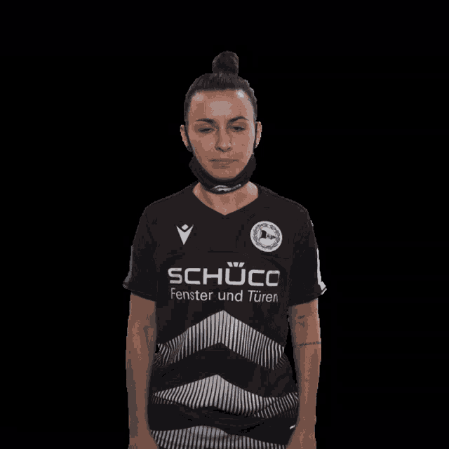 a woman wearing a mask and a shirt that says schuco