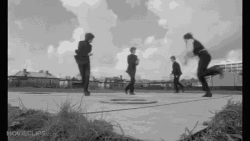 a group of people are dancing on a sidewalk with movieclips.com written in the corner