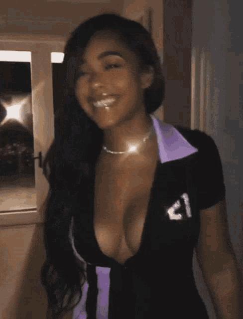 a woman with a plunging neckline and a shirt that says ' a ' on it