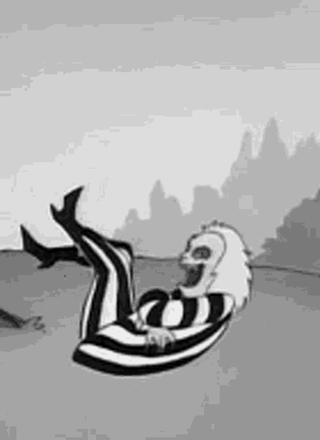a black and white cartoon of a cartoon character laying on his back .