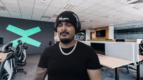 a man wearing headphones and a beanie with the word blizzard embroidered on it