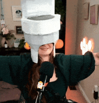 a woman wearing a hat made out of toilet paper