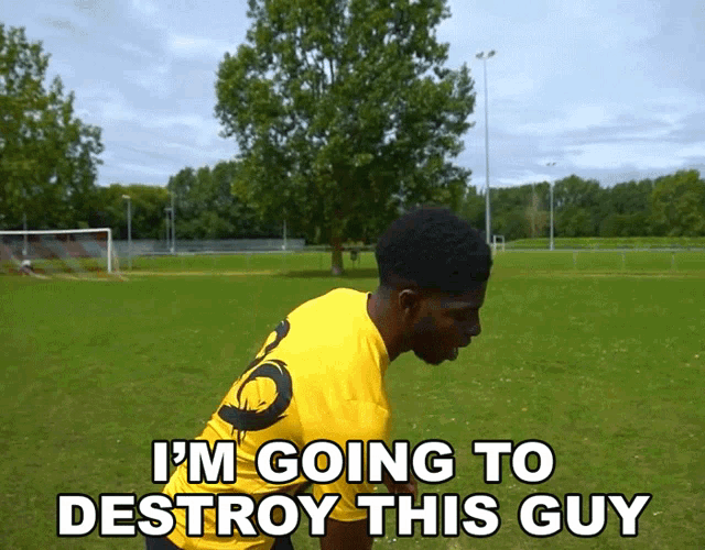 a man in a yellow shirt that says i 'm going to destroy this guy