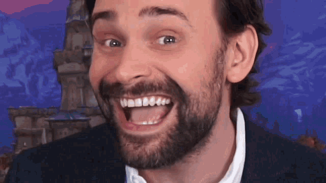 a man with a beard is making a funny face with his tongue hanging out