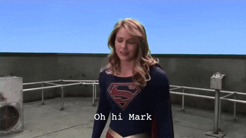 a woman in a superman costume stands on a roof and says oh hi mark