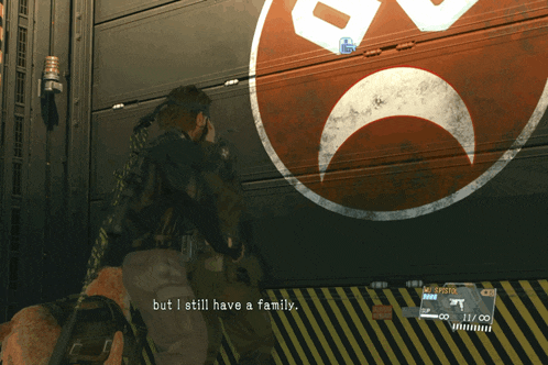 a man standing in front of a wall with a red and white smiley face on it