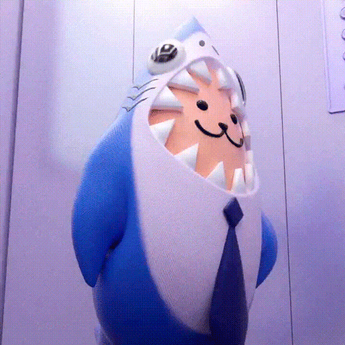 a stuffed animal with a shark head and a tie