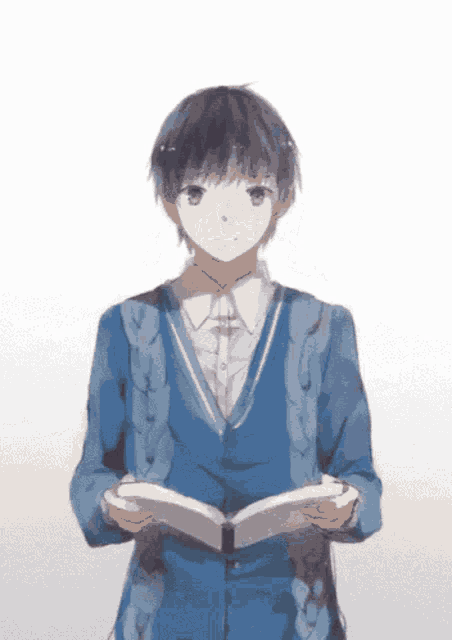 a boy in a blue jacket is holding a book in his hands