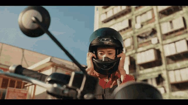 a woman wearing a helmet that says hjc