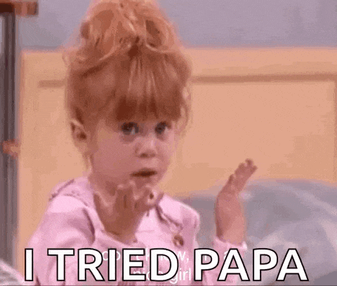 a little girl is making a funny face and saying `` i tried papa '' while sitting on a bed .